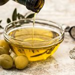 Hair Growth Natural Oils Olive Oil for Scalp Health: A bottle of olive oil with olives, focusing on the scalp health benefits of olive oil.